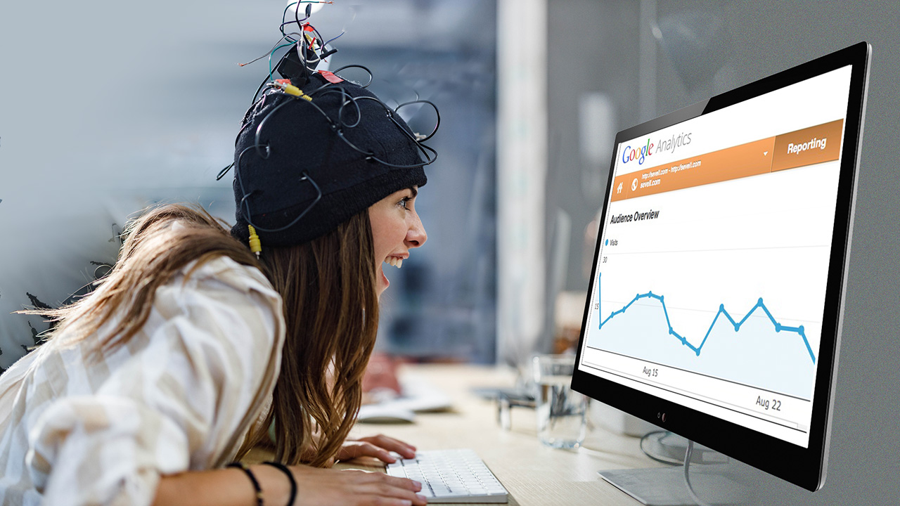 Excited woman wesring a wired hat, looking at Google analytics