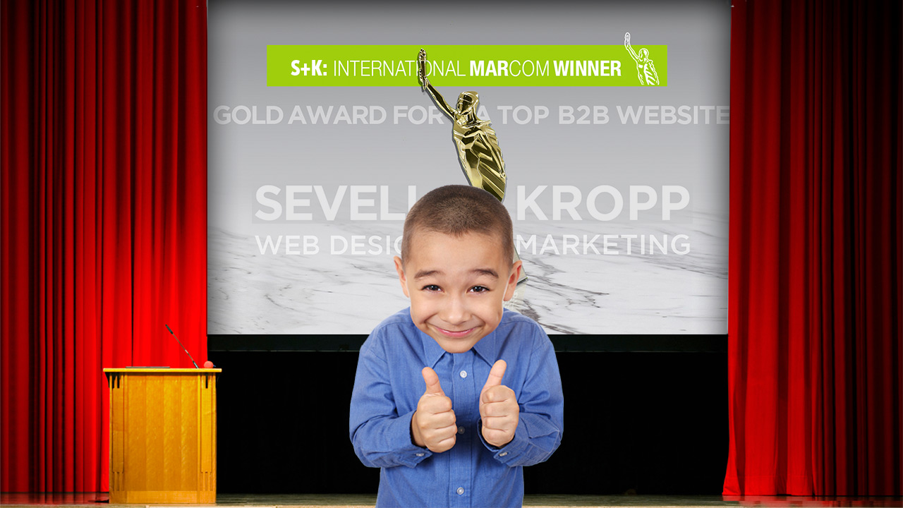 Little kid showing off MarComm award