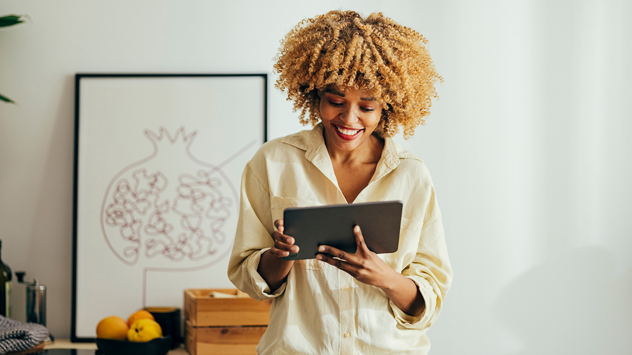 Woman Reading an E-newsletter on a Tablet