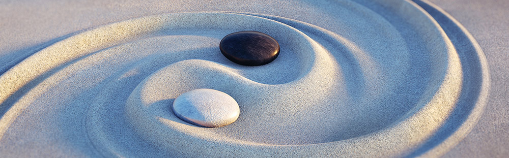 Yin Yang stones in sand