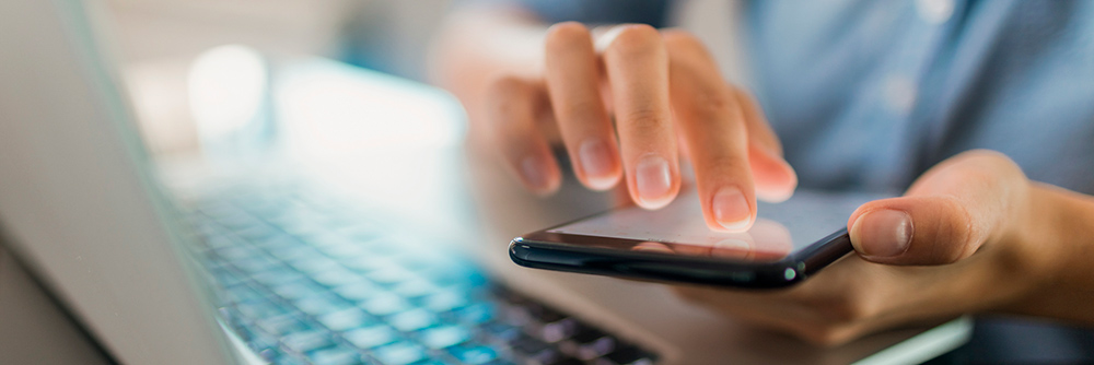 Person on laptop and phone