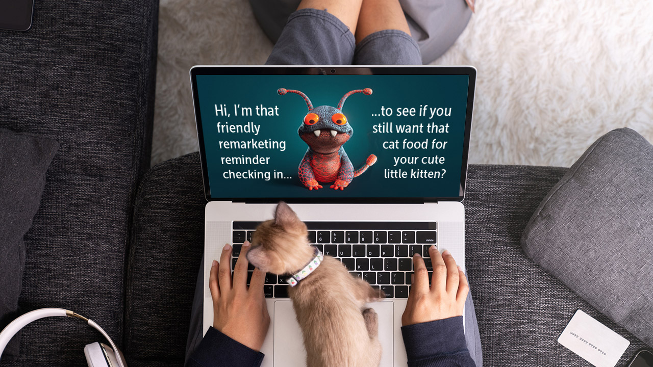 Woman on laptop at home with kitten on herlap