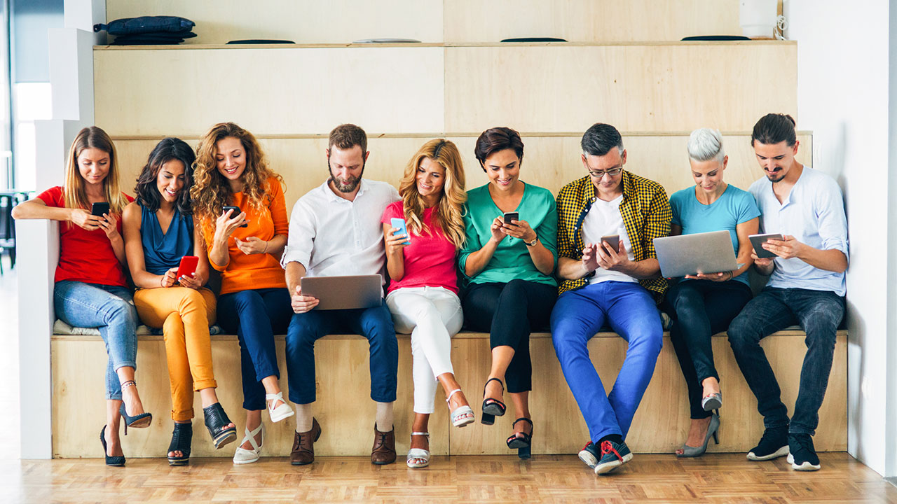 9 people on laptops and cell phones