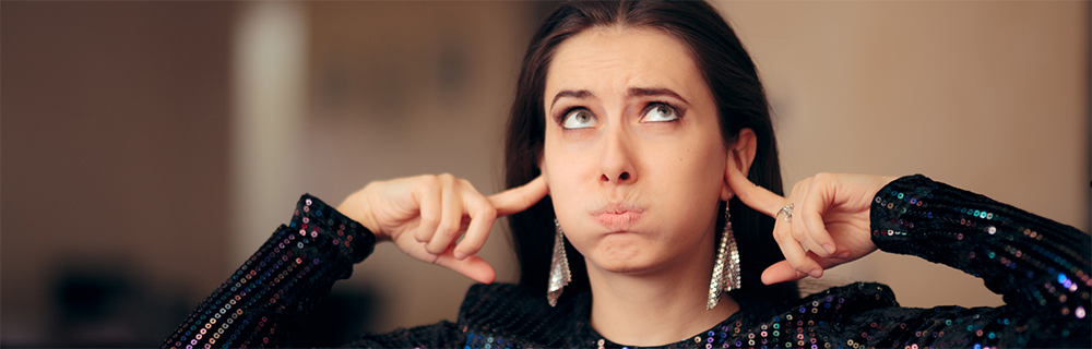 Bored woman blocking out sound