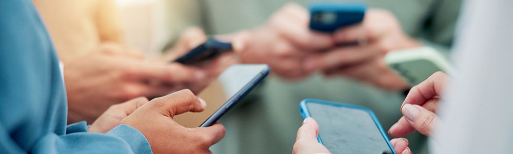 Group of people looking at their cell phones