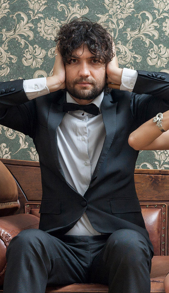 Man in suit with his hands over his ears