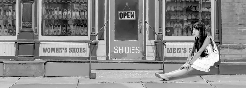 Shoe store with a barefoot kid sitting outside